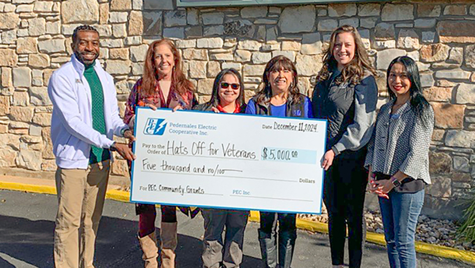 Photo of PEC employees with representatives from the Hats Off for Veterans organization.