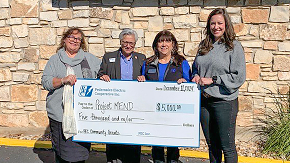 Photo of PEC employees with representatives from Project Mend organization.