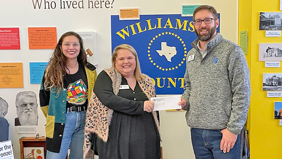Photo of PEC employee with representatives from the Williamson Museum.